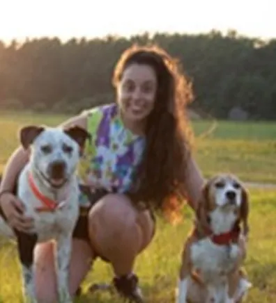 Abby in a field with 2 dogs